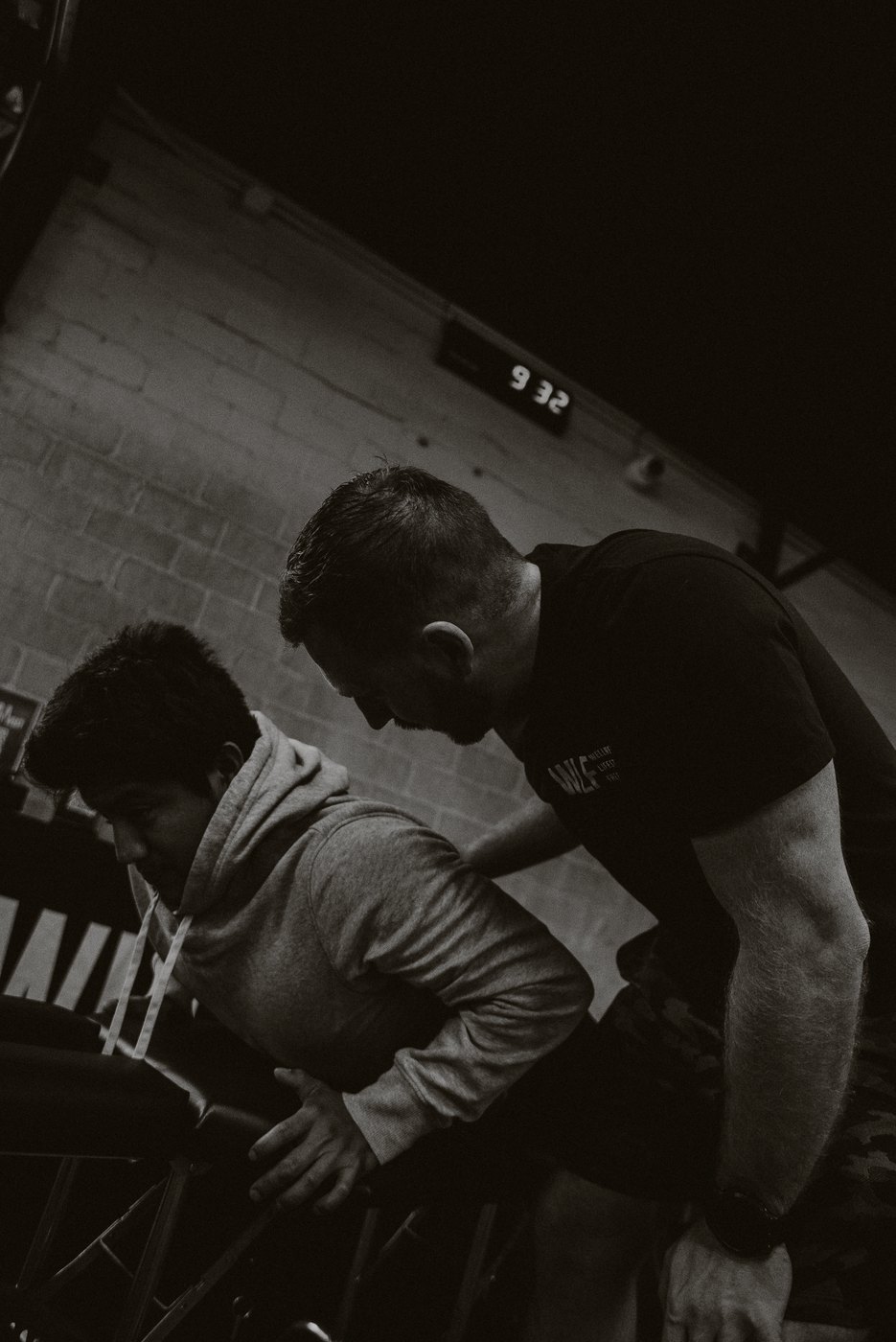 A WLF practitioner working hands-on with a client, shot in black and white.