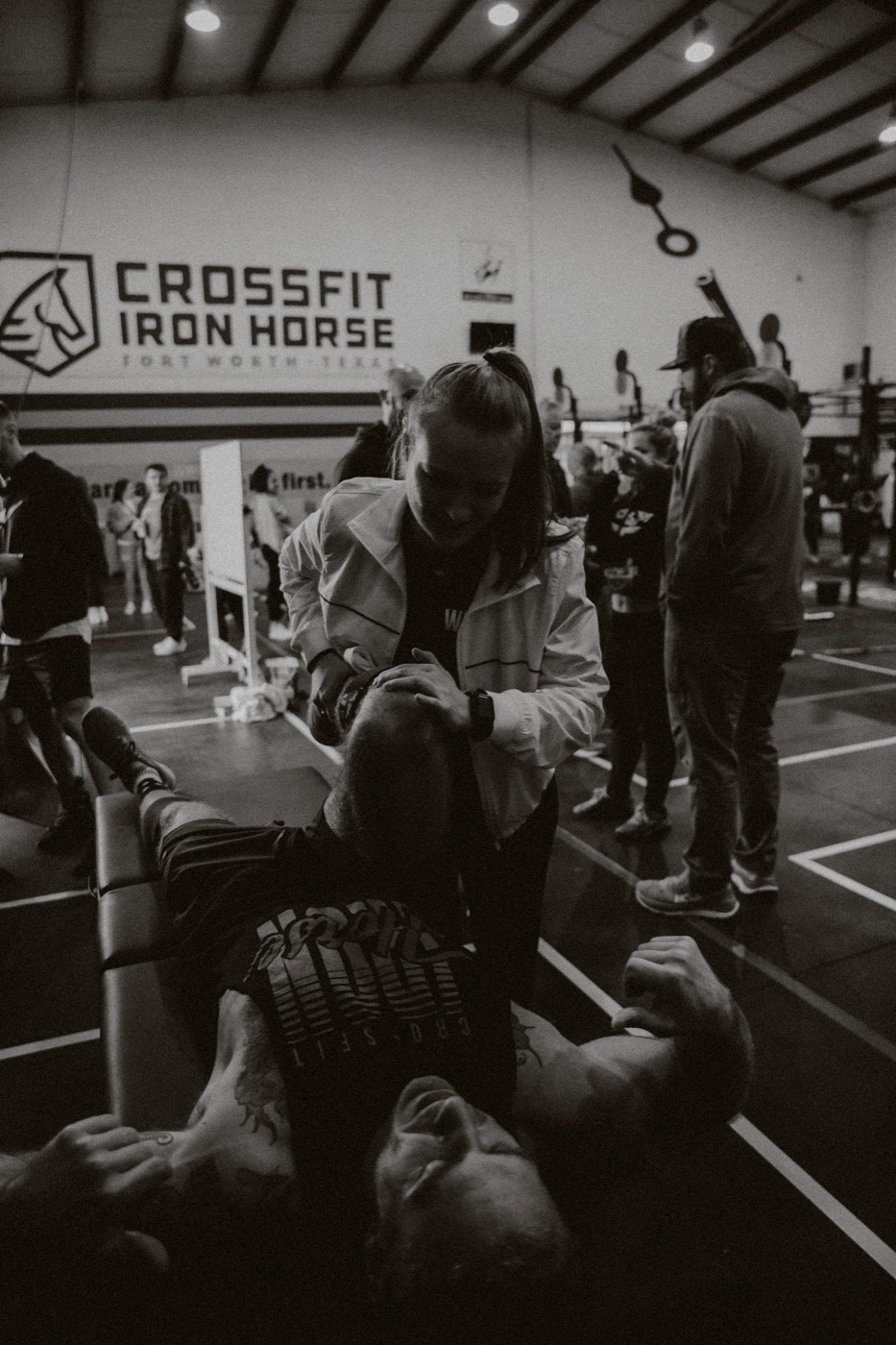 A WLF staffer working on an athlete's neck and shoulders on a treatment table at a community event.