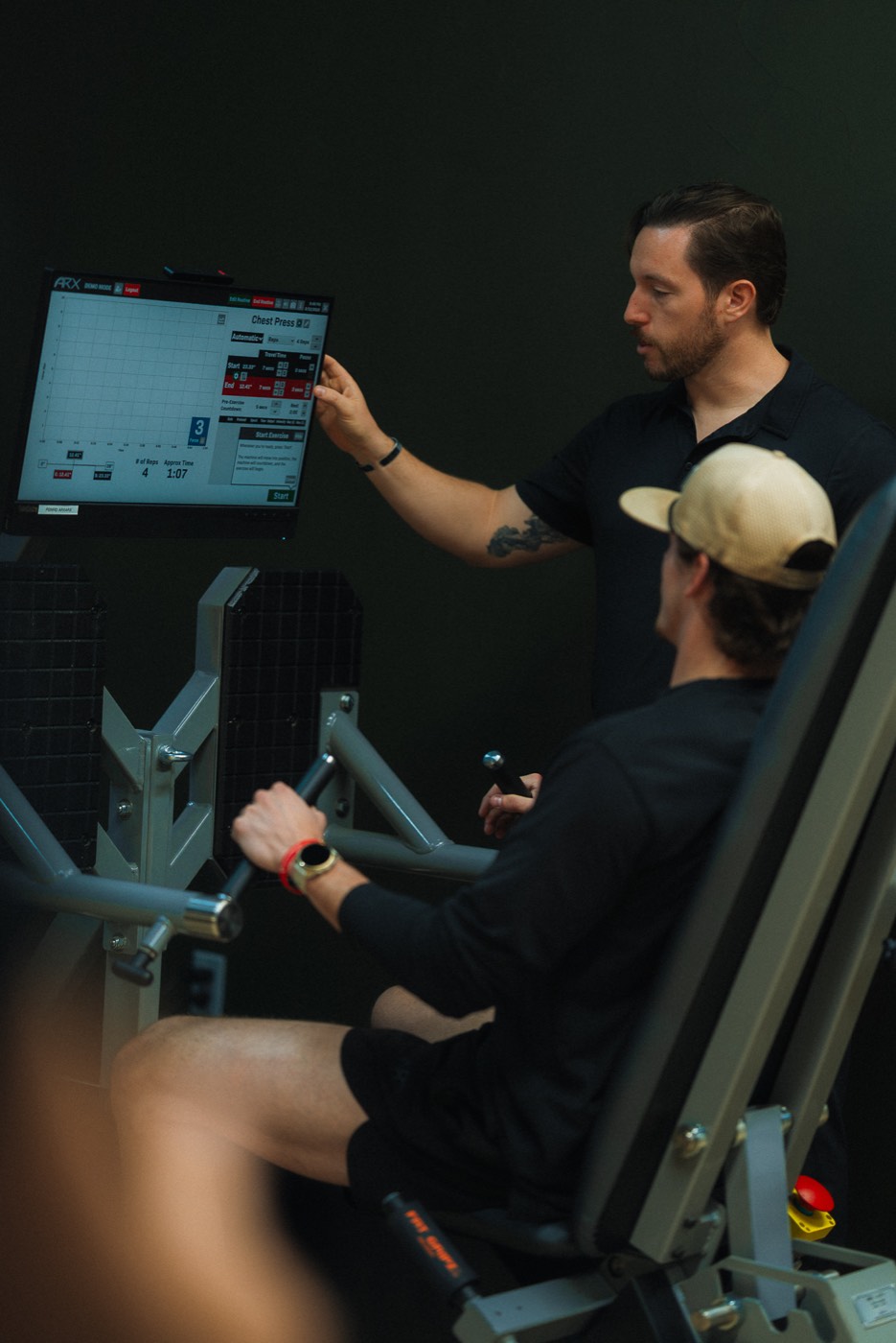 A WLF coach walking a member through his numbers on the ARX screen.