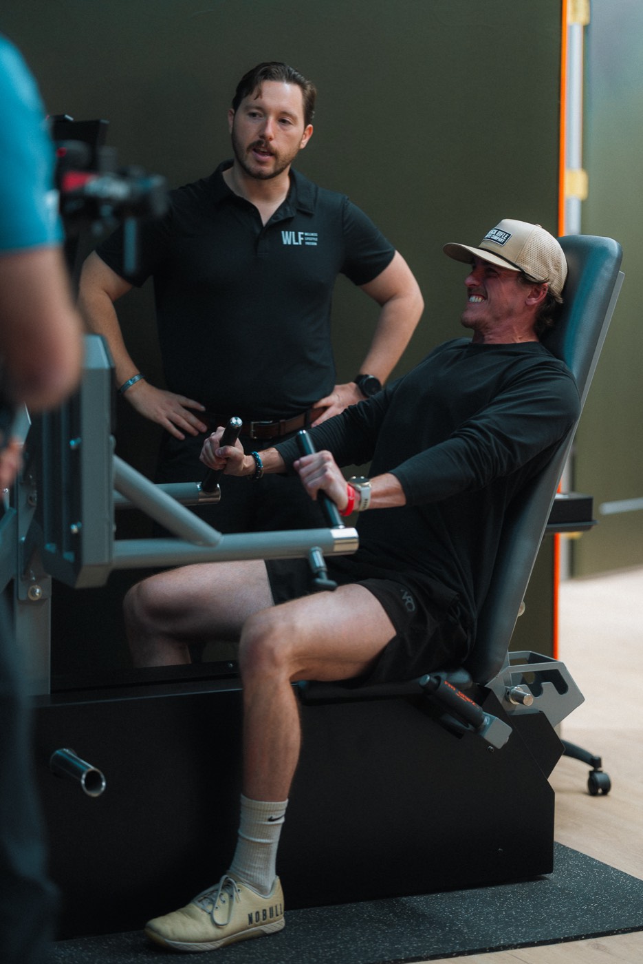 A WLF coach with a member mid-set on the training floor.