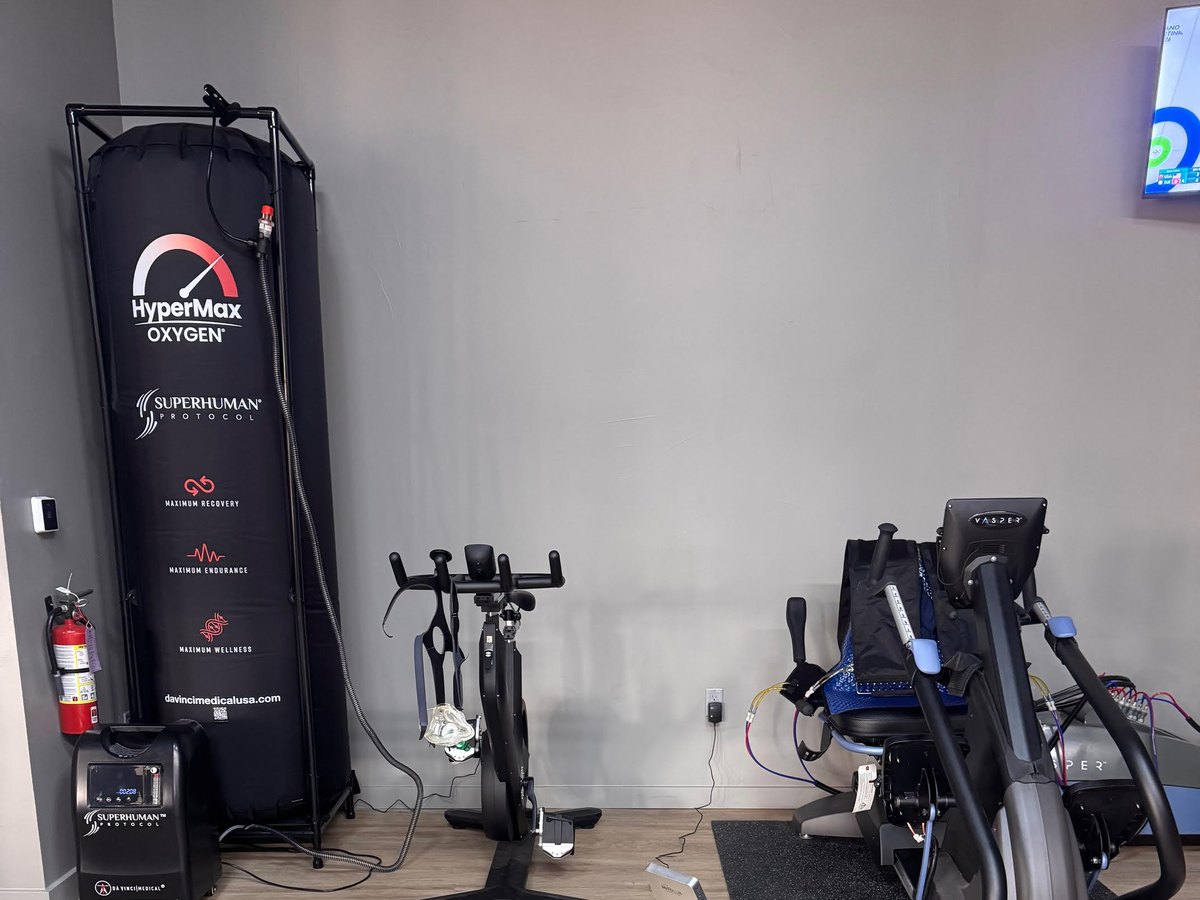 A HyperMax oxygen chamber, a stationary bike, and the Vasper machine in the training room at WLF Club.