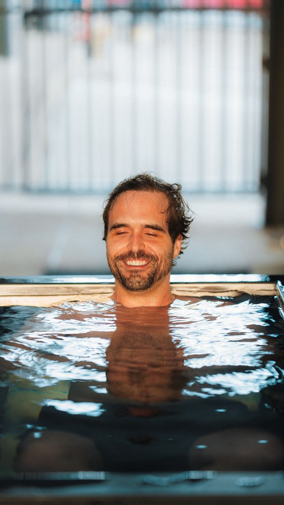 A member resting in the cold plunge at WLF Club.